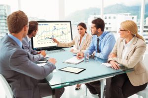 Young business people in board room meeting at office